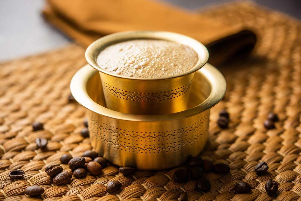South Indian filter coffee served in a traditional brass davara and tumbler